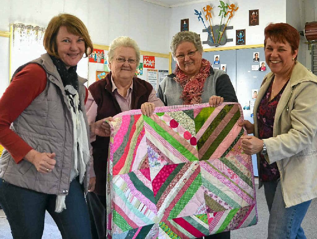 RACES AND LACES: Julie Leggatt, Olive Mullins, Elaine Nilson and Adele MacKinnon with the beautiful quit to be raffled off at next month’s Relay For Life.